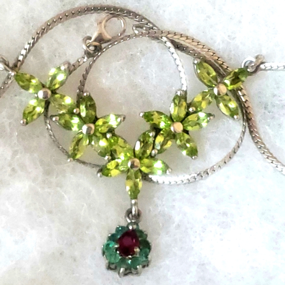 Silver 925 necklace with flowers made from turquoise, ruby, and peridot gems.